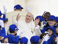 Pope Francis plays with children during the weekly Papal General Audience in Saint Peter's Square, Vatican City, 04 May 2022. (
