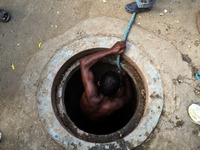An indian municipal worker comes out from an underground sevage chamber after cleaning,in Allahabad,on October 2,2015.Thursday marks one yea...