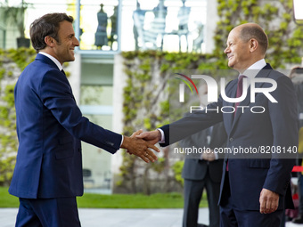 German Chancellor Olaf Scholz greets French President Emmanuel Macron upon his arrival at the Chancellery in Berlin, Germany on May 9, 2022....