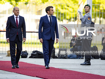 German Chancellor Olaf Scholz and French President Emmanuel Macron review the guard of honour at the Chancellery in Berlin, Germany on May 9...