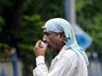 A man sips tea during rainfall in Kolkata, India, 10 May, 2022.  (