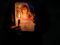 Palestinians light candles during a demonstration in Gaza City on May 11, 2022, in protest against the killing of Al Jazeera journalist Shir...
