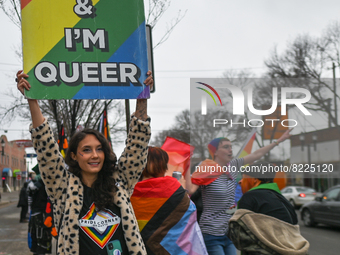 An activist holds a placard with words 'I'm Here and I'm Queer'.More than 100 local LGBTQ2S + supporters gathered Friday evening at the sou...