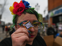 An activist holds a sign 'Pride Corner On Whyte'.More than 100 local LGBTQ2S + supporters gathered Friday evening at the southeast corner o...