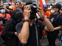A Photojournalist that also part of labor during his covrrage at location. labor held may day in front of house of representatives, the even...