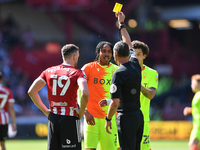 Referee, Andre Marriner shows a yellow card for unsporting behaviour to Djed Spence of Nottingham Forest and Jack Robinson of Sheffield Uni...