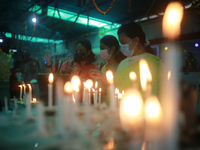 Buddhist devotees light candles at a temple during the Buddha Purnima festival in Dhaka, Bangladesh on May 15, 2022. (