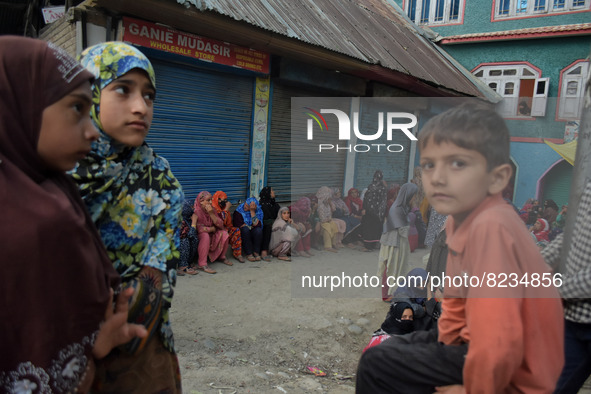 People await the body of a slain civilian Shoaib Ahmad Ganai who was killed after Indian forces allegedly shot him dead near his shop in the...