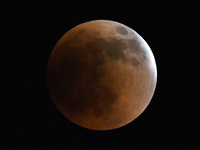 May 15, 2022 - The moon is almost completely covered in the earth’s shadow during a lunar eclipse on May 15, 2022 in Orlando, Florida. The 9...
