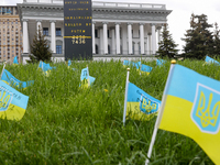 A man set an makeshift memorial with Ukrainian flags for Ukrainian civilians and foreign citizens killed by Russian servicemen during the in...