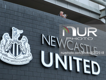 A general view as a fan reads a programme before the Premier League match between Newcastle United and Arsenal at St. James's Park, Newcastl...