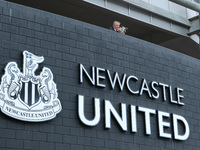 A general view as a fan reads a programme before the Premier League match between Newcastle United and Arsenal at St. James's Park, Newcastl...