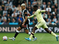 Burno Guimaraes of Newcastle United and Nuno Tavares of Arsenal in action during the Premier League match between Newcastle United and Arsen...