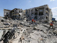 Ukrainian workers walk next to damaged resort building caused by a rocket strike in Odesa region, Ukraine on 16 May 2022. As a result of roc...