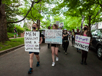 Pro-choice protesters march in the street in front of Supreme Court Justice Brett Kavanaugh's house in Chevy Chase, MD.  Demonstrators began...