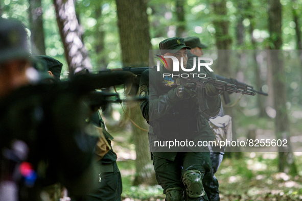 ZAKARPATTIA REGION, UKRAINE - MAY 19, 2022 - A National Guard serviceman carries a rifle during a tactical medicine exercise, Zakarpattia Re...