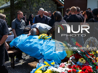 VELYKYI BEREZNYI, UKRAINE - MAY 11, 2022 - Family members stay by the coffin with the body of Ukrainian soldier Vasyl Pekar, 37, who perishe...