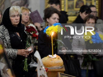 KYIV, UKRAINE - MAY 18, 2022 - People pay their last respects to 95th Separate Air Assault Brigade officer, Lt Denys Antipov who perished wh...