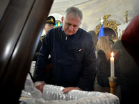 KYIV, UKRAINE - MAY 18, 2022 - A man pays his last respects to 95th Separate Air Assault Brigade officer, Lt Denys Antipov who perished whil...