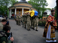 KYIV, UKRAINE - MAY 18, 2022 - Servicemen carrying the coffin with the body of 95th Separate Air Assault Brigade officer, Lt Denys Antipov w...