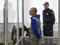 Russian soldier Vadim Shishimarin, 21, suspected of violations of the laws and norms of war,  inside a cage during a court hearing, amid Rus...