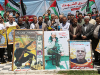 Palestinians take part in a rally demanding Israel to return the bodies of Palestinians who were killed by the Israeli army and detained aft...