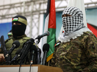 Palestinian militants from the joint operations room of the Palestinian resistance factions attend the national conference on the first anni...