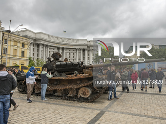 People look at destroyed Russian armored vehicles displayed for Ukrainians to see at Mykhailivska Square in downtown Kyiv, Ukraine, May 22,...