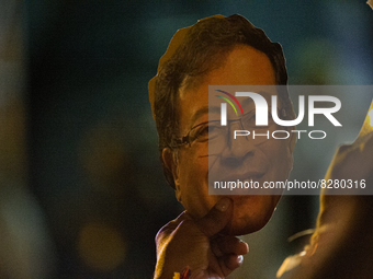 A supporter holds a cut-out face of presidential candidate Gustavo Petro during the closing campaign rally of left-wing presidential candida...