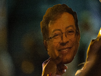 A supporter holds a cut-out face of presidential candidate Gustavo Petro during the closing campaign rally of left-wing presidential candida...