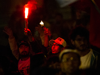 A supporter lights up a firework during the closing campaign rally of left-wing presidential candidate for the political alliance 'Pacto His...