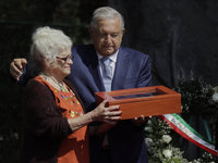 Andrés Manuel López Obrador (left), President of Mexico, hands over a box with a flag to Martha Recaséns Díaz de León (right), widow of Arno...