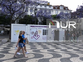 People are seen walking near a COVID-19 test stand located in Rossio square. Lisbon, May 23, 2022. Portugal is the European Union country wi...