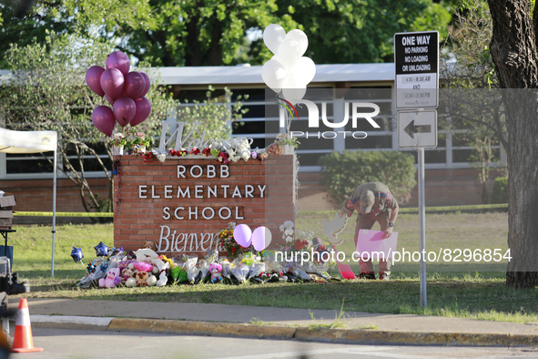 Officers helped bring items from loved ones to the Robb Elementary School sign in Uvalde, Texas, May 25, 2022.  