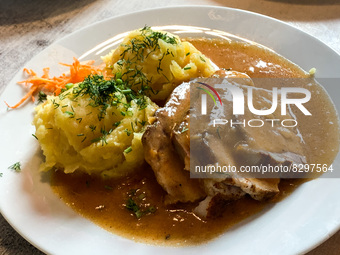 A roast in sauce with potatoes is seen in a milk bar in Krakow, Poland on May 24, 2022. (