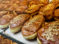 Filled doughnuts called Paczki are seen in a storefront in Krakow, Poland on May 25, 2022. (