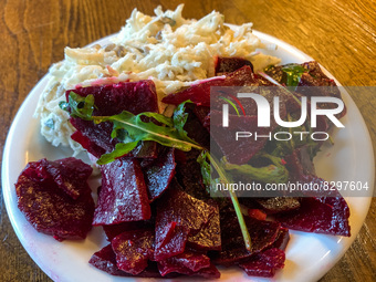 Beetroot and celery salad are seen on a vegetarian restaurant table in Krakow, Poland on May 25, 2022. (