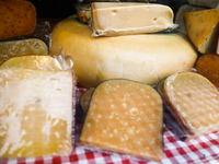 Yellow cheeses are seen on a stand in Krakow, Poland on May 25, 2022. (