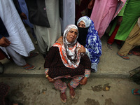  Women wail outside the houses which were damaged during the gun-battle in south Kashmir's Pulwama on May 30, 2022.Two militants of Jaish-e-...