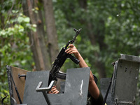  An Indian army man lifts his assault rifle near the site of gun-battle in south Kashmir's Pulwama on May 30, 2022.Two militants of Jaish-e-...