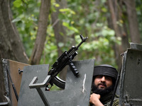  An Indian army man looks on near the site of gun-battle in south Kashmir's Pulwama on May 30, 2022.Two militants of Jaish-e-Muhammad milita...