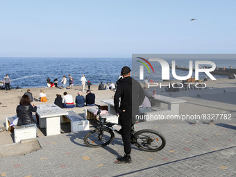 People rest at the embankment of the Black sea next to closed beach in Odesa, Ukraine on 29 May 2022. The beach season in Odesa is usually o...