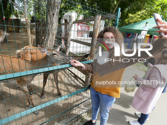 A visitor takes a selfie with animals at the Odesa Zoo, in Odesa, Ukraine on 29 May 2022. Odessa Zoo has been located near the Privoz market...
