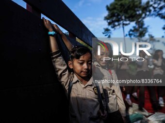 Students are huddling together in a truck to going school in Tugu Utara Village, Regency Bogor, West Java province, Indonesia on 2 June, 202...
