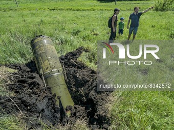 Some civilians stand near the remains of a russian Tochka rocket nailed in a field in the outskirts of Kostiantynivka city, Donbass. Rocket...