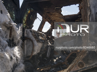 A man looks at the cabin of destroyed Russian armored Kamaz Typhoon displayed for Ukrainians to see at Mykhailivska Square in downtown Kyiv,...