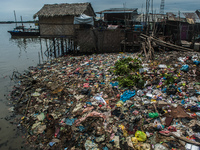 Household plastic waste is seen filling the side of a fisherman's settlement of Belawan sea coastal in Medan, North Sumatra province, Indone...