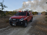 Athens, Greece. 4th June 2022. A fire brigade vehicle operates in the region of Voula as wildfire blazes across the slopes of Mount Hymettus...