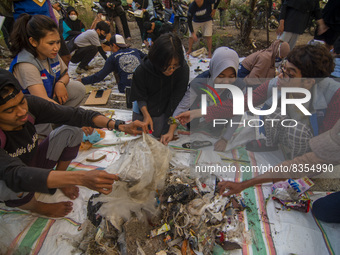 Environmental activists sort out samples of plastic waste in Palu Bay Beach, Central Sulawesi Province, Indonesia on June 5, 2022. The sampl...