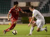 Ye Ko Oo (L) of Myanmar is closed down by Lebanon player during their 2018 FIFA World Cup Qualifier Asian group G match at Suphachalasai Sta...